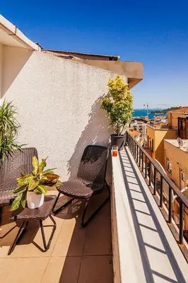 a balcony with chairs and potted plants on a building at Stories Of Galata in Istanbul