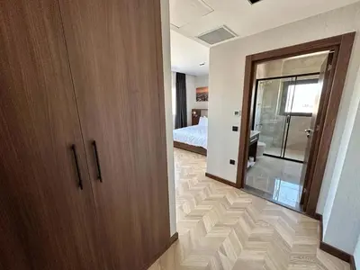 a room with a door and a bedroom with a bed at Plaza Residence in Tuzla