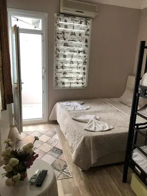 a bedroom with a bed and a window with a windowtaining at Theodora Hostel in Istanbul