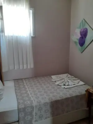 a bedroom with a bed with a purple flower on it at Theodora Hostel in Istanbul