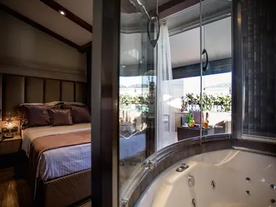a bathroom with a tub next to a bed at Bonne Sante Hotel in Istanbul