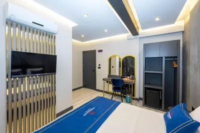 a bedroom with a large bed and a desk at İstanbul Paradise Hotel in Istanbul