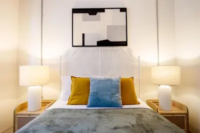 a bedroom with a bed with two lamps at Stylish Modern Flat Steps from Istiklal in Istanbul