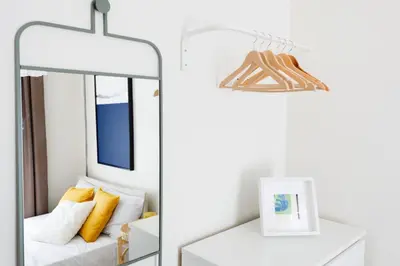 a mirror in a living room with a white couch at Stylish Modern Flat Steps from Istiklal in Istanbul
