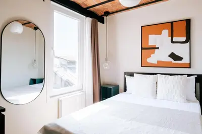 a bedroom with a bed and a mirror at Stunning City View Luxury Flat by Galata Metro in Istanbul