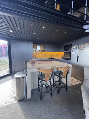 a kitchen with a large kitchen island with stools at Baraka 1 in İznik