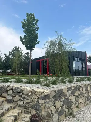 a building with a tree and a stone wall at Baraka 2 in İznik