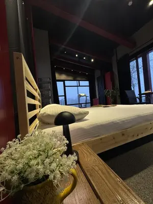 a bedroom with a large bed and a table with flowers at Baraka 2 in İznik