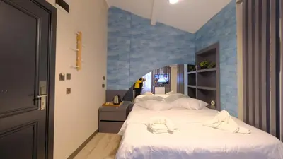 a bedroom with two beds and a blue wall at Marine Suite in Istanbul