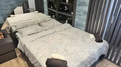 a bedroom with a bed with a white comforter and pillows at Marine Suite in Istanbul