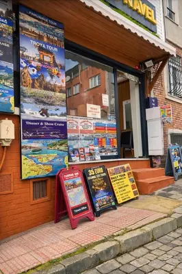 a store with signs on the side of a building at Hes Sultanahmet Tenedos in Istanbul
