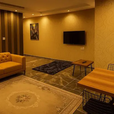 a living room with a couch and a flat screen tv at Nera Otel in Istanbul