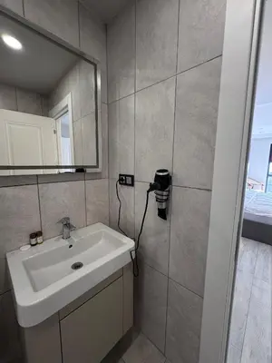 a bathroom with a sink and a mirror at Valenzasuites in Tuzla