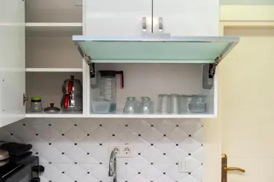 a kitchen with a sink and a shelf with dishes at Amoria House Sultanahmet in Istanbul