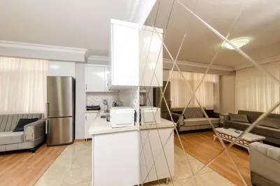 a kitchen with a refrigerator and a living room at Amoria House Sultanahmet in Istanbul