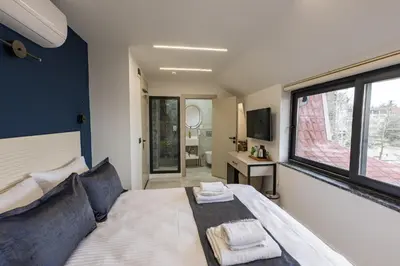 a bedroom with a bed and a large window at Safir Termal & Spa Otel in Çekirge İstasyonu