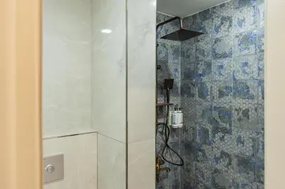 a shower with a glass door in a bathroom at Safir Termal & Spa Otel in Çekirge İstasyonu