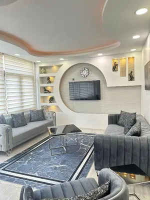 a living room with couches and a clock on a wall at Ekinci Plaza in Istanbul