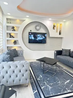 a living room with a couch and a tv on a wall at Ekinci Plaza in Istanbul