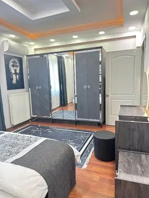 a bedroom with a bed and some lockers and a mirror at Ekinci Plaza in Istanbul