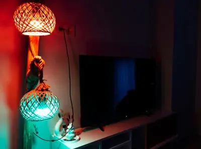 a lamp sitting on a table next to a television at House in Istanbul