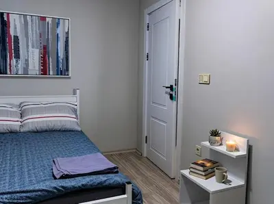 a bedroom with a bed and a door with books at House in Istanbul