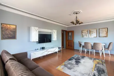 a living room with a couch and a table at Spacious & Modern 3BR Apartment Central Şişli in Istanbul