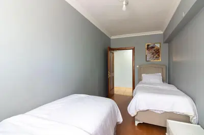 a bedroom with two beds and a doorway at Spacious & Modern 3BR Apartment Central Şişli in Istanbul
