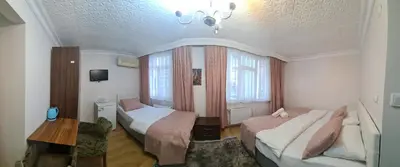 a hotel room with two beds and a chandelier at BACHOS HOTEL SULTANAHMET sea view terrace in Istanbul