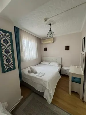 a small bedroom with a bed and a window at BACHOS HOTEL SULTANAHMET sea view terrace in Istanbul