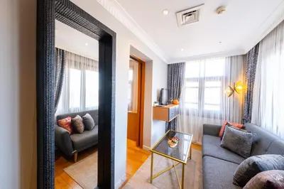 a living room with a couch and a mirror at King Suite Hotel Beşiktaş in Istanbul
