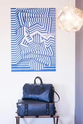 a suitcase sitting on a table in front of a painting at Maroon Hotel Pera in Istanbul