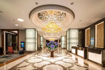 a lobby with a large chandelier and flowers on a floor at Sheraton Grand Istanbul Atasehir in Istanbul