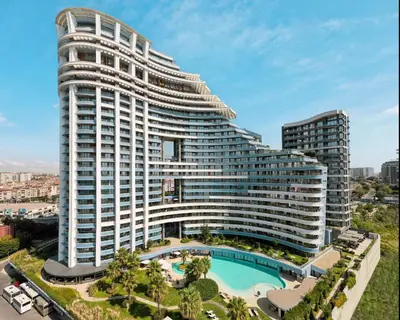 a large building with a pool in front of it at Radisson Blu Hotel Istanbul Ottomare in Istanbul