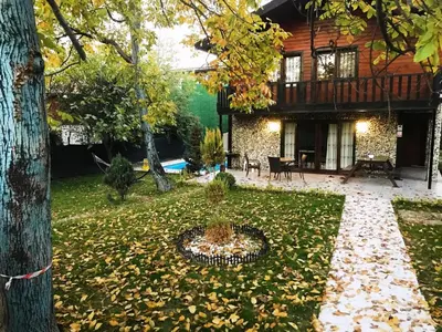 a yard with a fountain in front of a house at Sapanca Vi̇lla Bahce Şükriye Küçükal in Sapanca