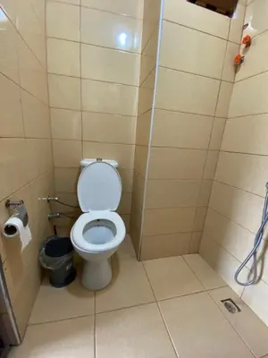 a small bathroom with a toilet in a stall at Lapina Suite & Restaurant in Cebeci