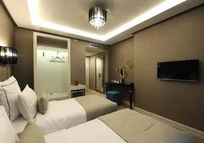 a hotel room with two beds and a flat screen tv at Le Petit Palace Hotel - Special Category in Istanbul