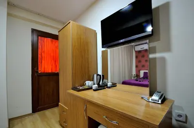 a room with a desk with a flat screen tv at Seyri Istanbul Hotel in Istanbul