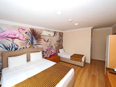 a bedroom with a bed and a pink flamingo mural at Seyri Istanbul Hotel in Istanbul