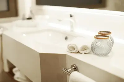 a bathroom with two sinks and a vase on a counter at Holiday Inn Bursa - City Centre by IHG in Bursa