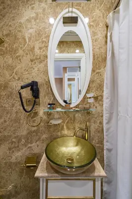 a bathroom with a green sink and a mirror at Alpek Hotel in Istanbul