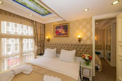 a bedroom with a large bed and a window at Alpek Hotel in Istanbul