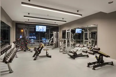 a gym with several treadmills and exercise machines at Fraser Place Antasya Istanbul in Istanbul
