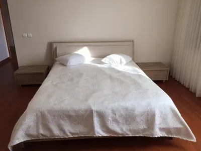 a bed with a white comforter and two pillows at Villa Bursa in Bursa