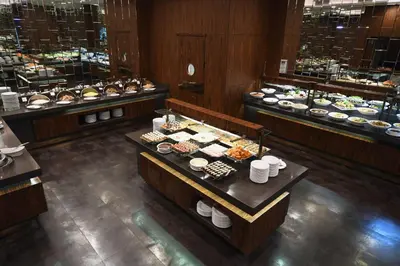 a restaurant with a buffet of food on tables at Mercure Istanbul West Hotel & Convention Center in Istanbul