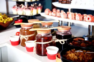 a shelf filled with jars of jam and other foods at Glamour Hotel Istanbul Sirkeci in Istanbul