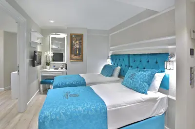 a bedroom with a large bed with blue accents at Glamour Hotel Istanbul Sirkeci in Istanbul