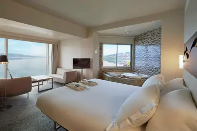 a bedroom with a large white bed and a large window at Richmond Nua Wellness Spa - Adult Only in Sapanca