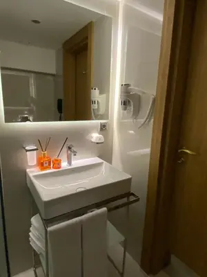 a bathroom with a white sink and a mirror at Lady Diana Hotel in Istanbul