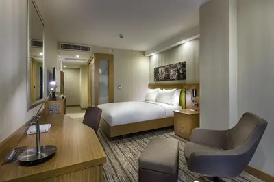 a hotel room with a bed and a desk at Hampton by Hilton Istanbul Atakoy in Istanbul